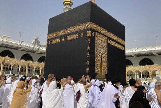 Muslim pilgrims circumambulate the Kaaba, the cubic building at the Grand Mosque, as they left social distancing during the minor pilgrimage, known as Umrah, in the Muslim holy city of Mecca, Saudi Arabia, Sunday, March 6, 2022. Saudi Arabia announced Saturday that It decided to end the precautionary and preventive measures related to combating the Covid-19 pandemic, the state news agency reported. (AP Photo/Amr Nabil)